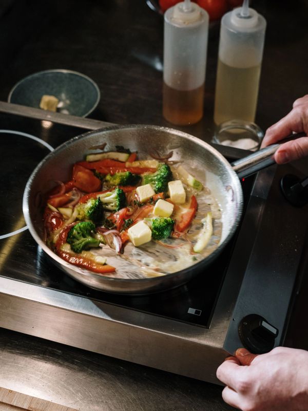 Cooking vegetables and cheese in a pan.