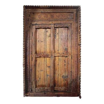 Pair of antique hand carved doors in frame. 
New York Props