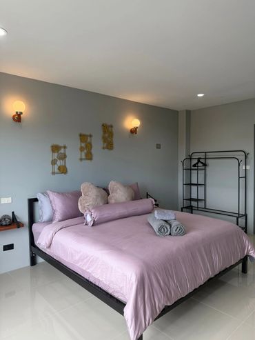 Modern bedroom with lavender bedding and minimalist decor.