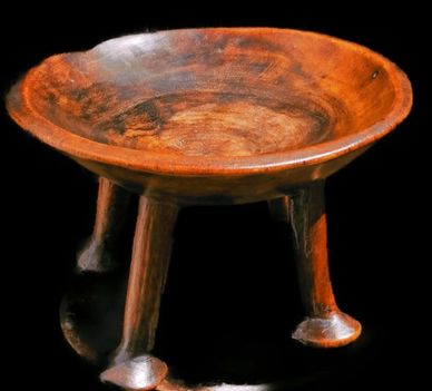 Wooden bowl with four legs.