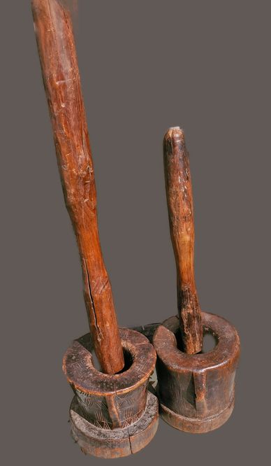 Two wooden traditional mortars with pestles.