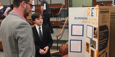 Young student adventor explaining his invention.