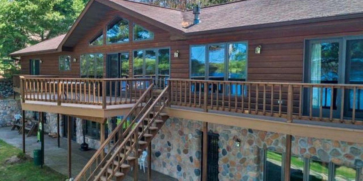 lakeside view of home showing roomy deck