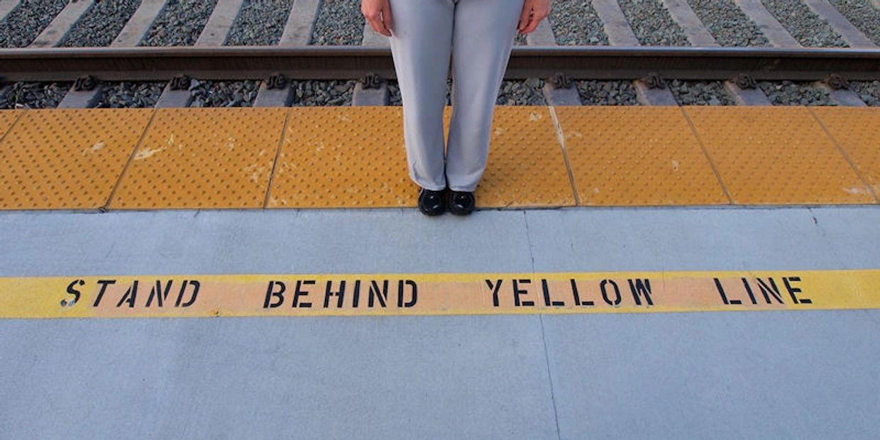 Standing behind the yellow line, which side are you on?