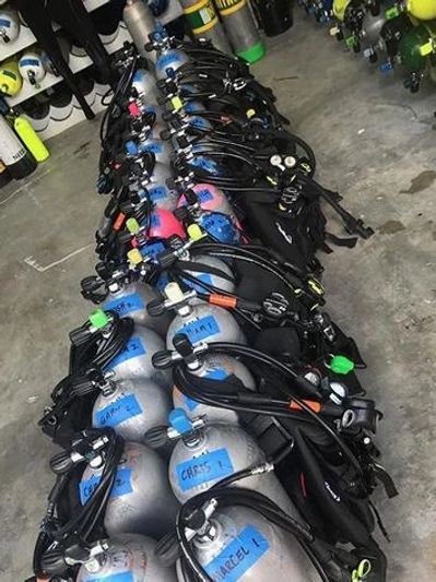 Scuba tanks and gear set up for rental at the dive shop