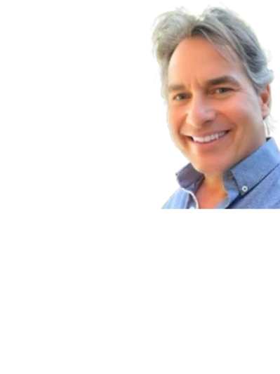 Close up image of a man with white color hairs smiling at the camera
