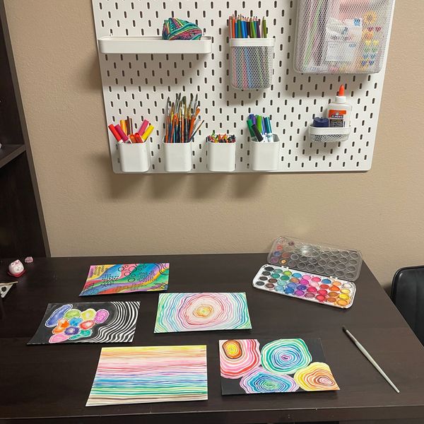 Art therapy supplies hanging on wall and art therapy desk in art therapist office in tallahassee