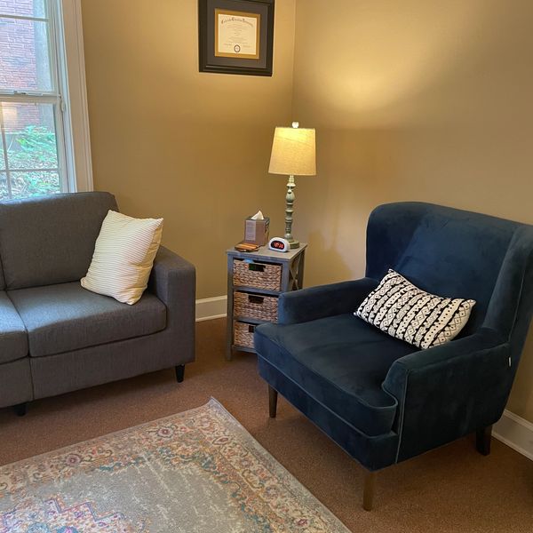 Therapy or counseling office with blue chair and grey couch in Tallahassee Florida. Therapist office