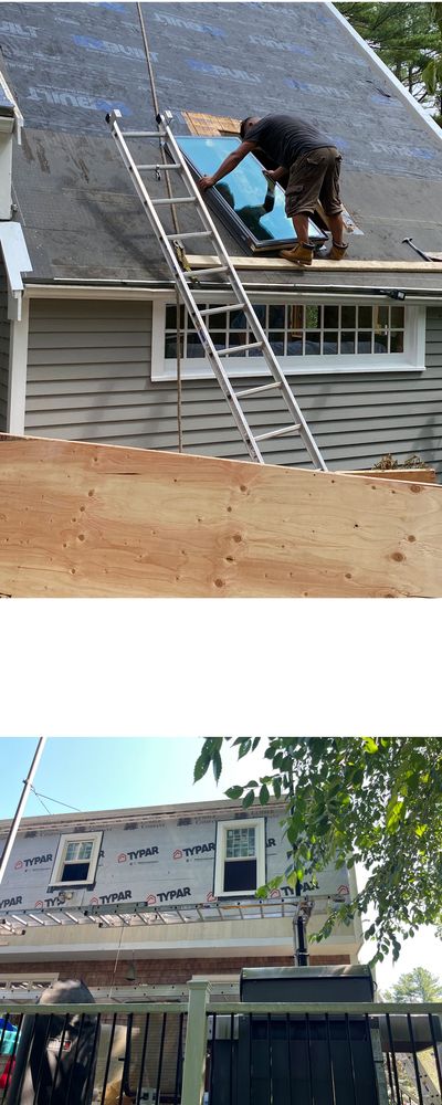Man working on installing a skylight,
House fitted with new windows