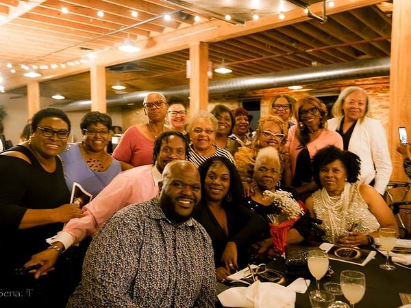 Group of people smiling & taking picture