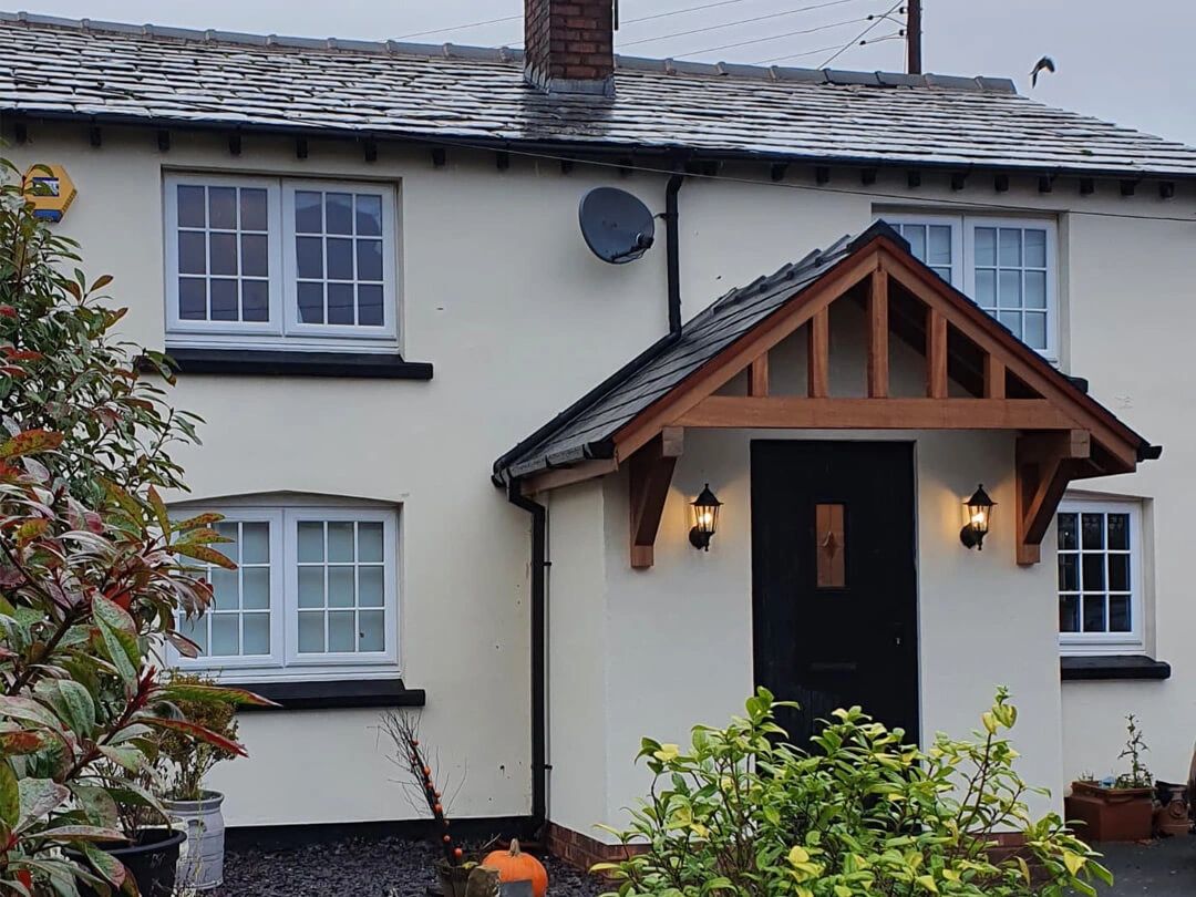 Cottage porch with timber canopy and slate roof