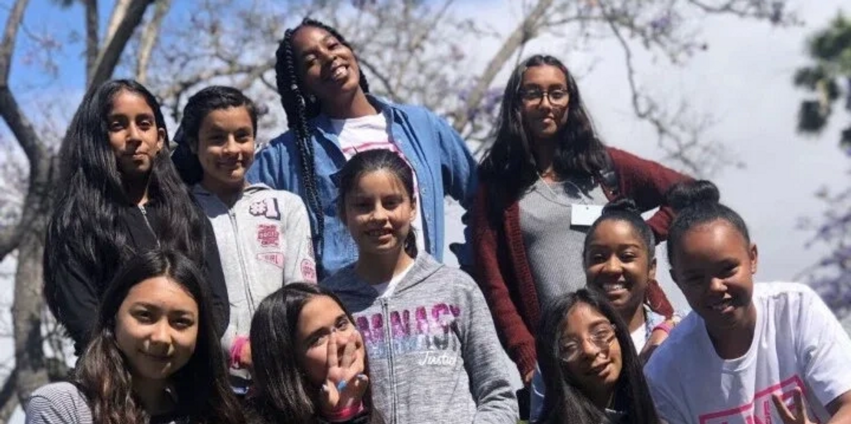 Girls posing for picture in park.