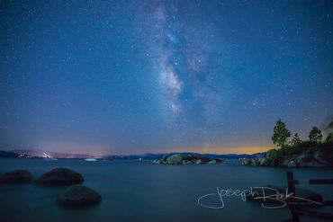 The milky way in light blue over Lake Tahoe during nautical twilight.