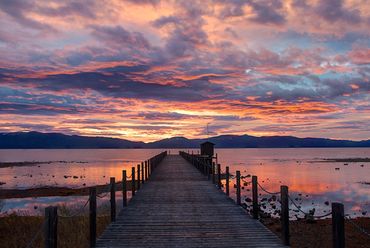 Amazingly colorful Lake Tahoe sunrise with an lonely pier.