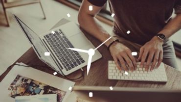 Person typing on keyboard with clock overlay symbolizing time management.