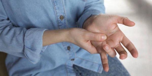 Person pressing their painful finger
