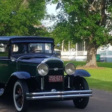 Classic vintage black car parked on a street.