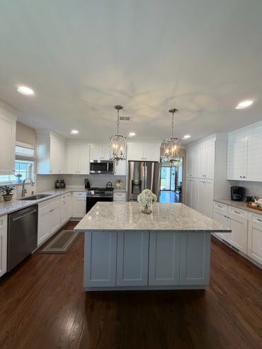 Bright modern kitchen with large island and pendant lights.