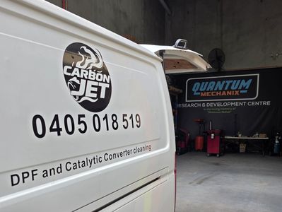 Van for DPF and catalytic converter cleaning parked inside a workshop.