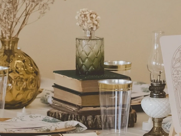 Elegantly set table with vintage decor and gold-rimmed glasses.