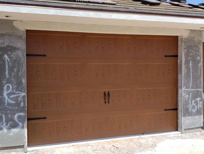 Faux wood Garage Door with optional carriage House Hardware.