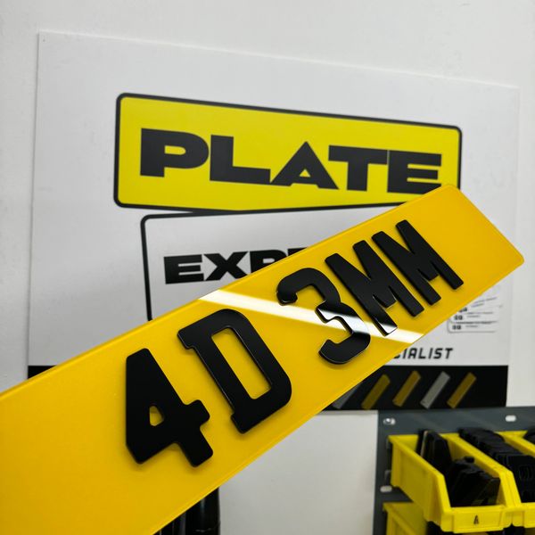 Yellow license plate with black characters 4D 3MH in a workshop.