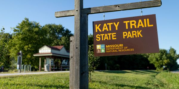 Sign for Katy Trail State Park in Missouri with a clear blue sky.