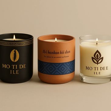 Three elegant candles in black, terracotta, and glass holders, each lit and beautifully designed.