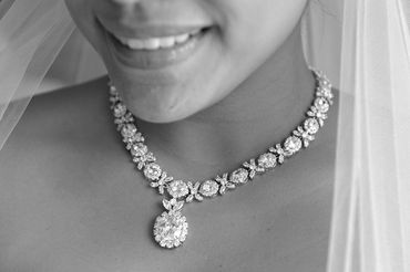 Close up shot of beautiful diamond necklace worn by the bride.