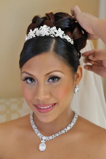 Head shot of beautiful Philipino bride getting her final touches to her hair.