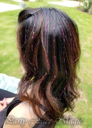 Cassie head shot from above of her pink hair tinsels.