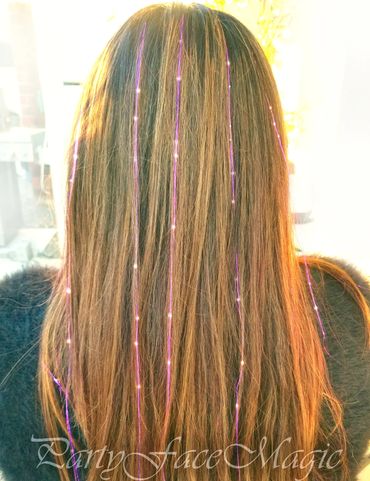 Brownish hair with purple hair tinsels.