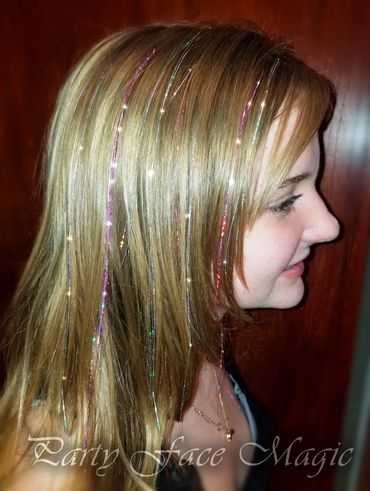 Pink and Silver Hair tinsels applied to blond hair.