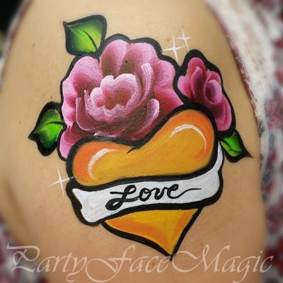 Face painting design of roses surrounding a yellow heart that says Love