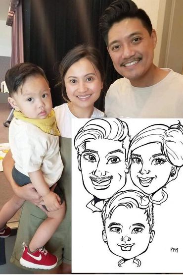 Philipino parents with their baby boy, holding their caricature drawing.