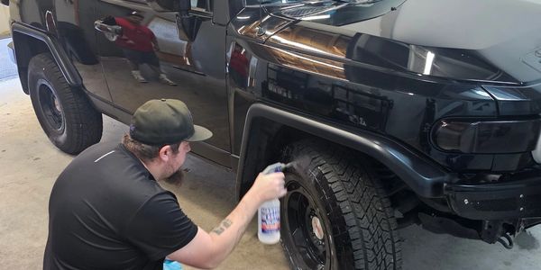 Tire Shine being applied to tires during an exterior detail 