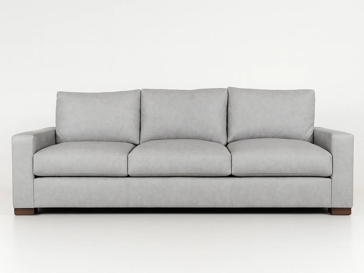 A modern grey three-seater sofa with wooden feet against a plain white background.