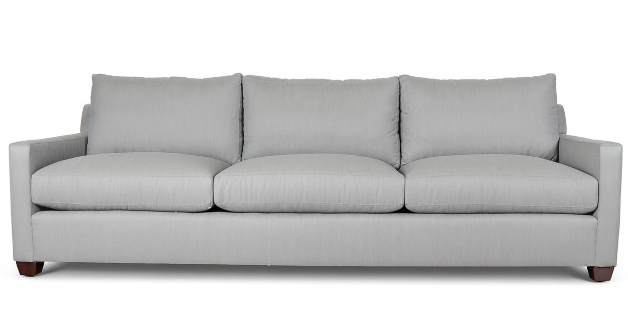 Modern light gray three-seater sofa with plush cushions and wooden legs.