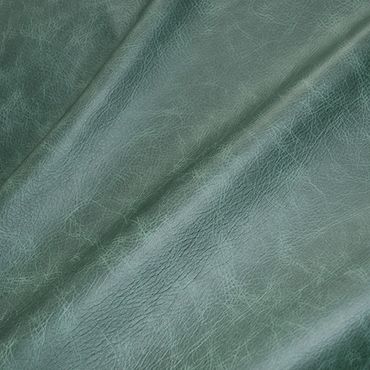 Close-up of textured green leather fabric with natural creases.