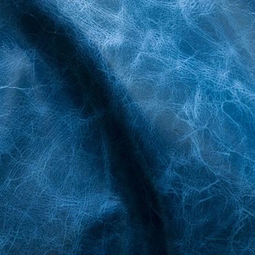 Close-up of textured blue leather material with natural creases.