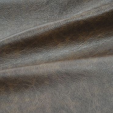 Close-up of textured brown leather material with natural creases.
