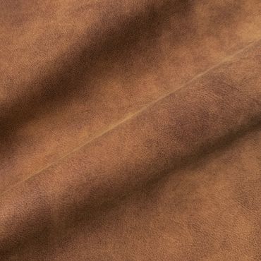 Close-up of textured brown leather fabric with natural grain.