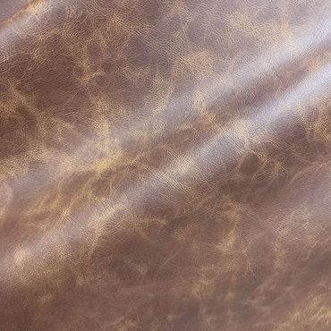 Close-up of textured brown leather material with natural creases.