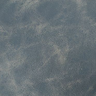 Close-up of textured blue leather surface with natural creases.