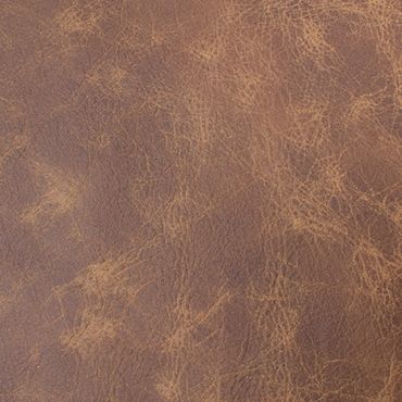 Close-up of textured brown leather surface with natural creases and patterns.