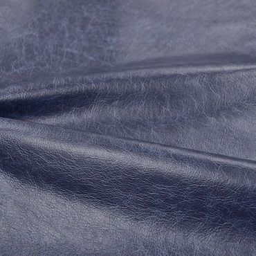 Close-up of dark blue textured leather material.