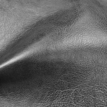 Close-up of textured black leather surface with natural creases.