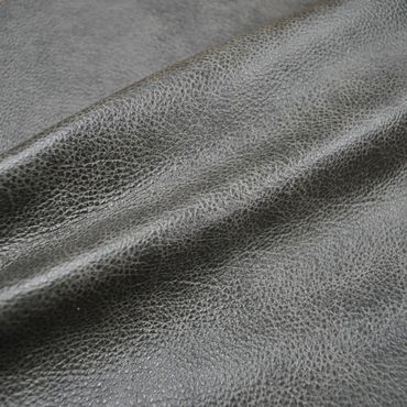 Close-up of textured black leather fabric with natural grain.