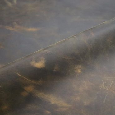 Close-up of textured, aged leather with natural creases and patina.
