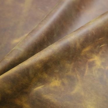 Close-up of folded brown leather with rich texture and natural grain.